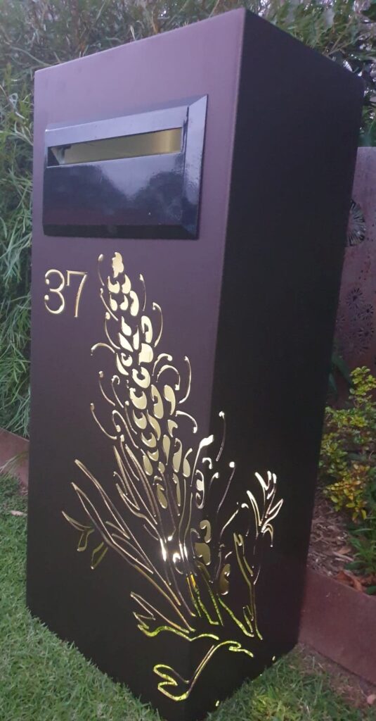 Standard Letterbox in Powder coated aluminium. Grevillea pattern. Black face plate.