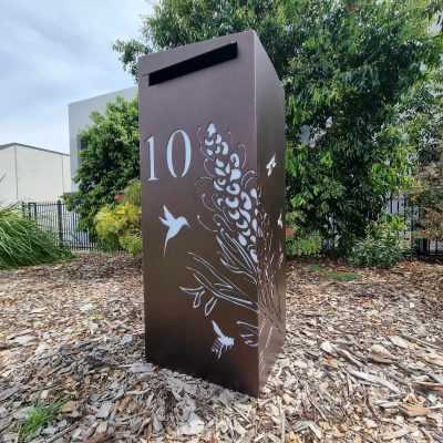 Medium LB Dulux Burnished Copper - Grevillea Hummingbird, bees, dragonflies Medium Letterbox in Powder Coated aluminium. Grevillea with Bees pattern.