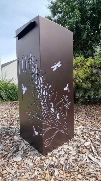 Medium LB Grevillea with bees, hummingbird, dragonflies Dulux Burnished Copper Medium Letterbox in Powder Coated aluminium. Grevillea with Bees pattern.