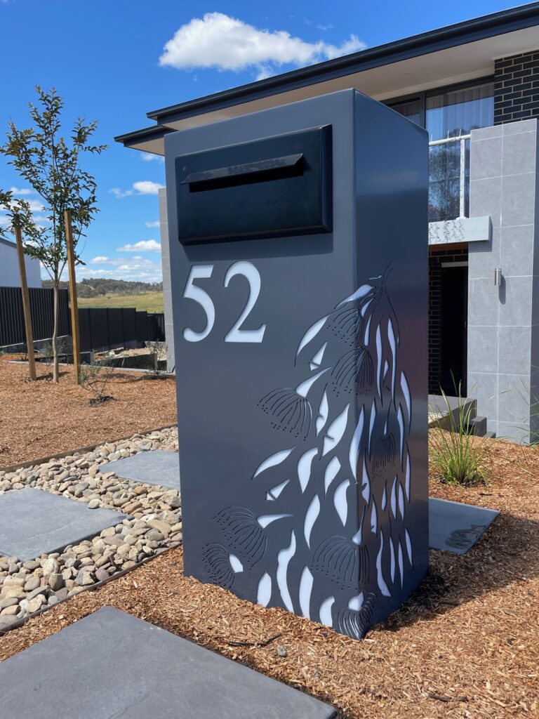 Standard Letterbox in Powder coated aluminium. Gum Leaf Cascade pattern. Black face plate.