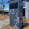 Standard Letterbox in Powder coated aluminium. Gum Leaf Cascade pattern. Black face plate.