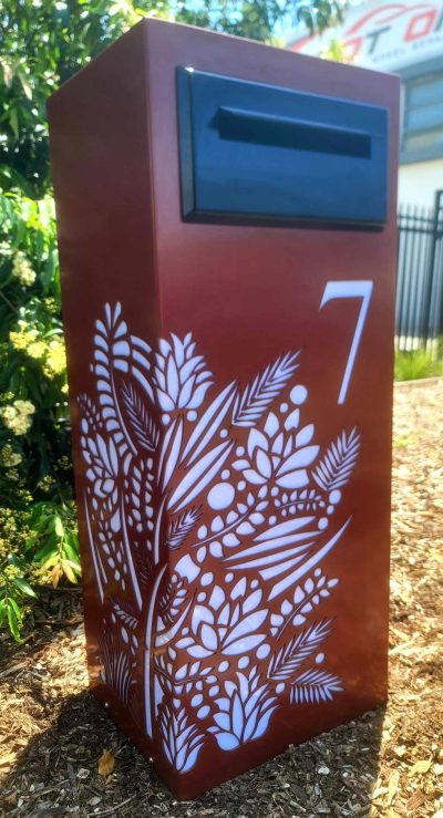 Std LB - Floral, Manor Red, perspex, Black Chute 1.0 Standard Letterbox in Powder coated aluminium. Floral pattern. Black face plate.