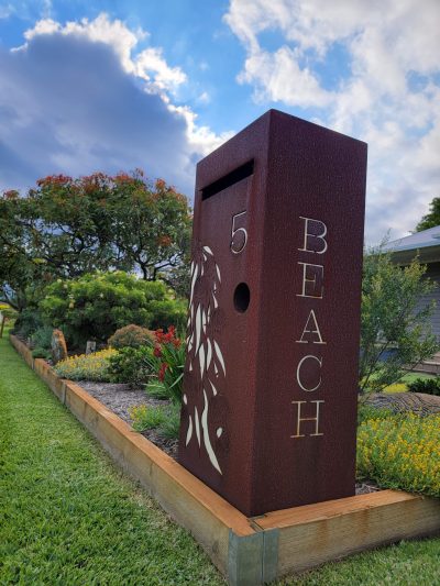 Std LB Gumleaf Cascade - rust 5 Beach side view Medium Letterbox in Cor-Ten steel. Grevillea pattern.