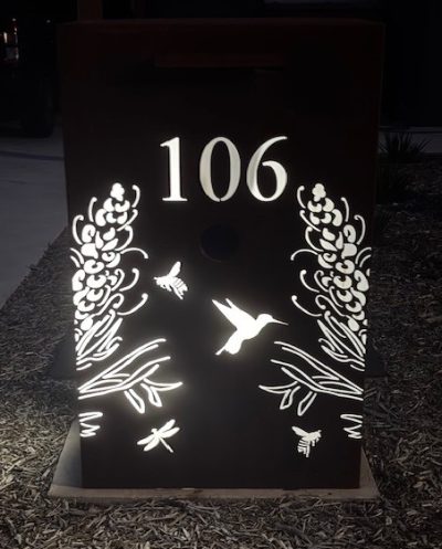 WF LB - Double Grevillea with bees, hummingbirds & dragonflies - front view Custom Metal Free standing Parcel Letterbox in Cor-Ten Steel. Grevillea with Honey eater pattern. Perspex.
