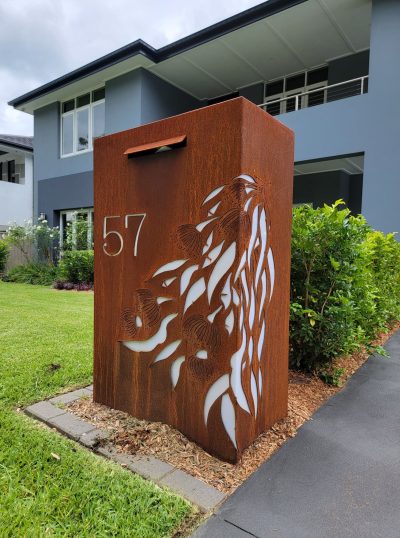 Wide Form Gumleaf Cascade MS with perspex - Harrington Park - Copy Custom Metal Free standing Parcel Letterbox in Cor-Ten steel. Gum leaf cascade pattern.