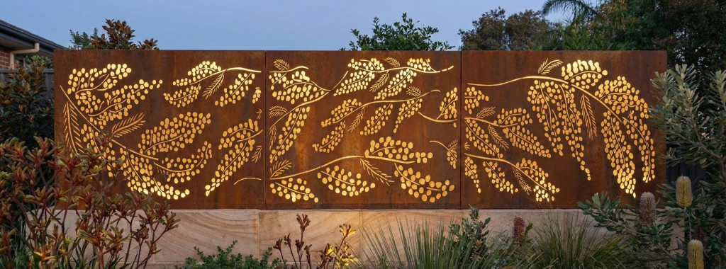 Cootamundra Wattle Panel in Cor-Ten Steel -outdoor setting. - backlit.